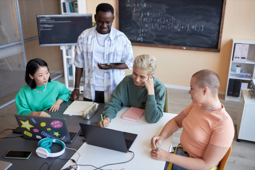 Team of high school students brainstorming while preparing presentation